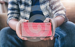 Close up hands of man holding bible on sofa at home. christian concept