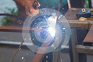Close-up of hands A man holding a welding machine and doing spot welding