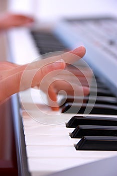 Close up of the hands of a man playing electronic keyboard or pi photo