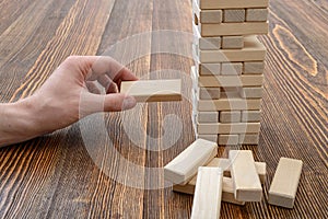 Close-up hands of man playing with wooden bricks