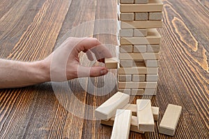 Close-up hands of man playing with wooden bricks