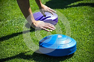 Close-up of hands of a man who is training and doing push-ups with balance tray