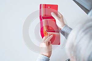 Close up of hands of mature woman looking and revising how many money she have in her wallet - empty wallet and needing money