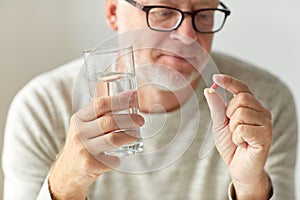 Close up of hands with medicine pills and water