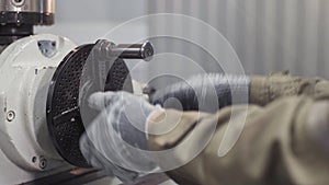 Close up hands of milling machine operator working in factory workshop. Turning lathe machine in turning workshop