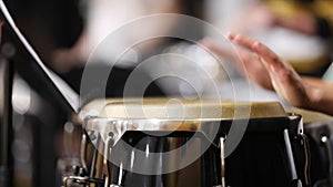 Close up of a drummer playing congas or bongos with their hands