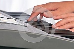 Close up of hands on a musical keyboard