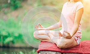 Close up hands at the nature background. Woman do yoga outdoor.