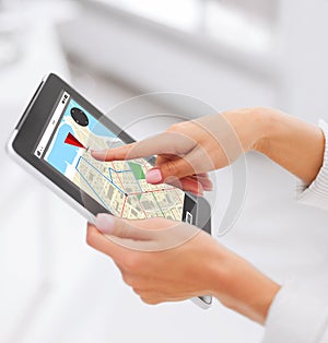 Close up of hands with navigator map on tablet pc