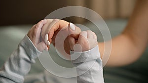 Close-up of the hands of a newborn and mother. Close-up baby hand on mother& x27;s hands. The hands of the child hold the