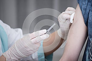 Close-up hands,nurses are vaccinations to patients using the syringe.Doctor vaccinating women in hospital.Are treated by the use