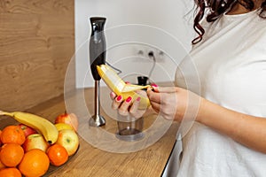 Close-up of Hands Peeling Banana for Healthy Snack in Home Kitchen