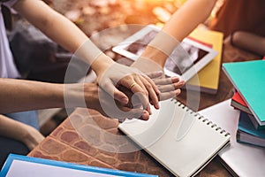 Close up hands of people putting and stacking their hands together. Friendship and Unity concept. Teamwork and Successful concept