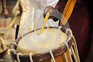 Close up of Hands performing Indian art form Chanda or chande cylindrical percussion drums playing during ceremony