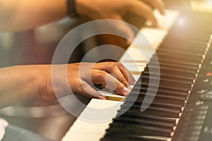 Close up hands of pianist musician playing keyboard synthesizer on band in night concert
