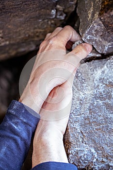 Close up of hands pinching small rock climbing holding