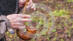 A close-up of the hands of a piper playing the bagpipe on the nature background photo