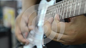 Close up hands playing electric guitar solo with speed picking technic