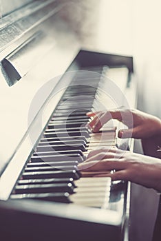 Close up of hands, playing piano