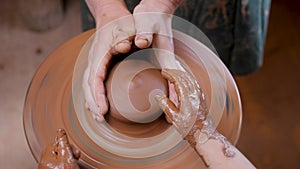 Close up hands pottery wheel pot clay potter child craft art education. Ceramic artist hand pottery wheel pot clay child