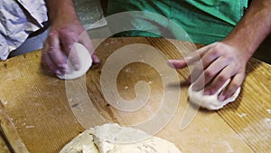 a close-up of hands preparing pizza dough