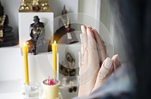 Close up of hands religious Asian buddhist woman praying