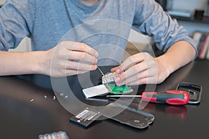 Close up of hands repairing a mobile phone