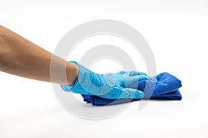 Close up of hands in rubber protective blue gloves cleaning the blue surface with a rag