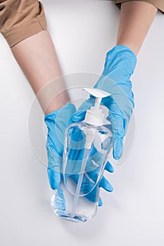 Close up of hands showing sanitizer gel bottle isolated on white background
