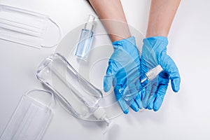 Close up of hands showing sanitizer gel bottle isolated on white background