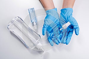 Close up of hands showing sanitizer gel bottle isolated on white background