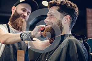Close-up of the hands of a skilled barber using a brush