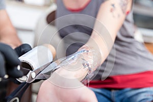 Close-up of the hands of a skilled tattoo artist