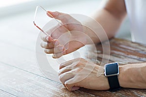 Close up of hands with smart phone and watch