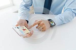 Close up of hands with smart phone and watch