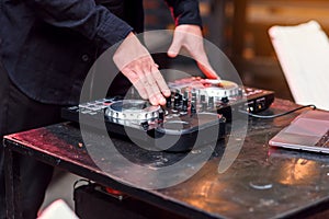 Close up of hands spinning the decks at the nightclub