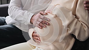 Close Up Of Hands Stroking Pregnant Belly