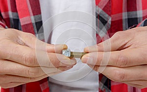 Close-up hands of a technician screwing a bolt