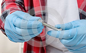 Close-up hands of a technician screwing a bolt