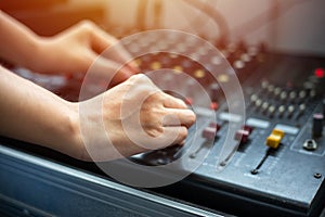 Close up hands tuning of sound mixer at control room