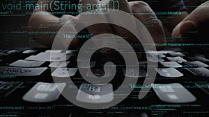 Close-up of Hands Typing on a Keyboard with Coding Text and Computer Programming Concepts in the Background xenic