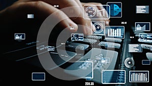 Close-Up of Hands Typing on Keyboard with Overlayed Digital Data and Analytics Visualizations in a Modern Workspace