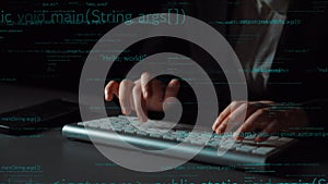 Close-up of Hands Typing on Keyboard with Programming Code in Background, Symbolizing Technology and Software