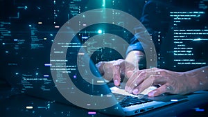 Close-up of hands typing on a laptop with glowing programming code and binary graphics, symbolizing cybersecurity technology