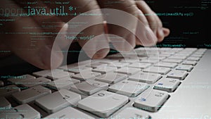 Close-up of Hands Typing on a Laptop Keyboard with Programming Code Overlay in a Dark Environment for Technology and