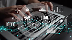 Close-Up of Hands Typing on Laptop Keyboard Surrounded by Digital Graphs and Data Visualizations in Modern Workspace