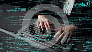 Hands Typing on Laptop with Programming Code Overlay in a Modern Office Setting, Concept of Software Development and