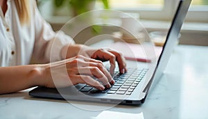 Close-up of hands typing on a modern black keyboard, sleek desk setup with a coffee cup and notepad in the background,