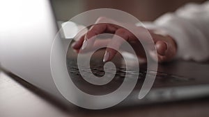 Close-up hands of unrecognizable middle-aged businesswoman working typing on laptop keyboard. Close-up cropped shot of