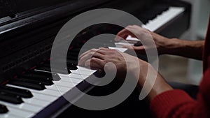 Close-up hands of unrecognizable musician man playing on synthesize gentle classical music at home recording studio